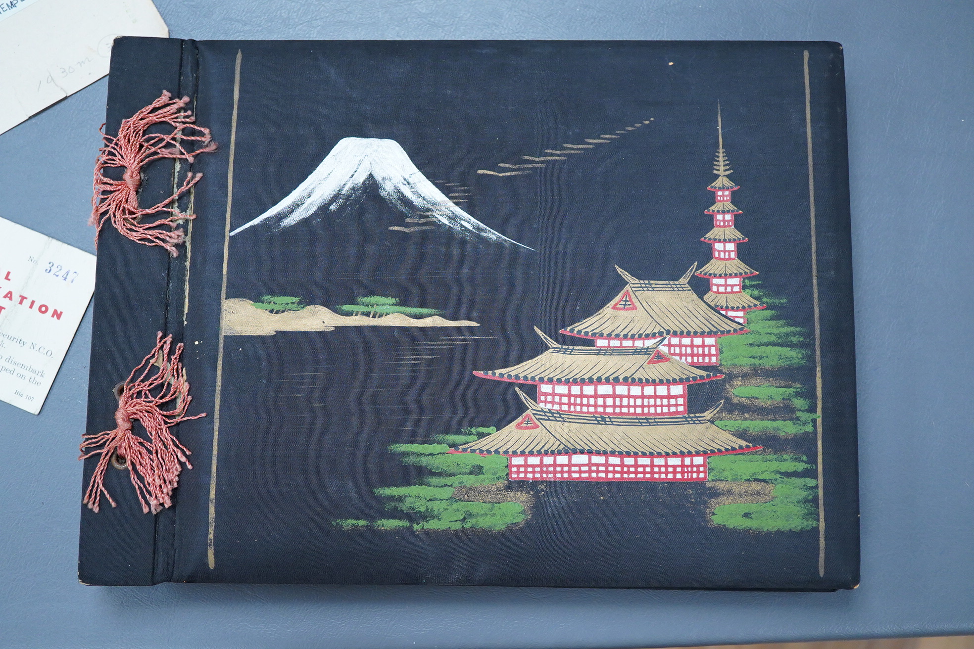 A Japanese photograph album, late 1940's to include banknotes and a telegram, together with a cigarette case